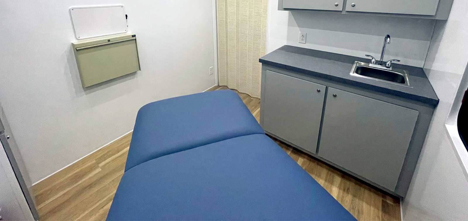 Medical examination room with sink.